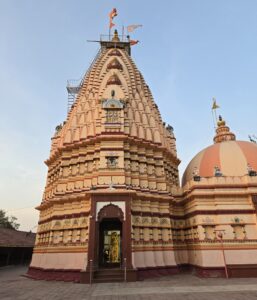 Peach and terracotta exterior of Shree Siddhnath Mahadev Mandir near Surat in the evening light