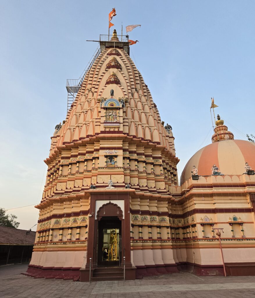 Peach and terracotta exterior of Shree Siddhnath Mahadev Mandir near Surat in the evening light