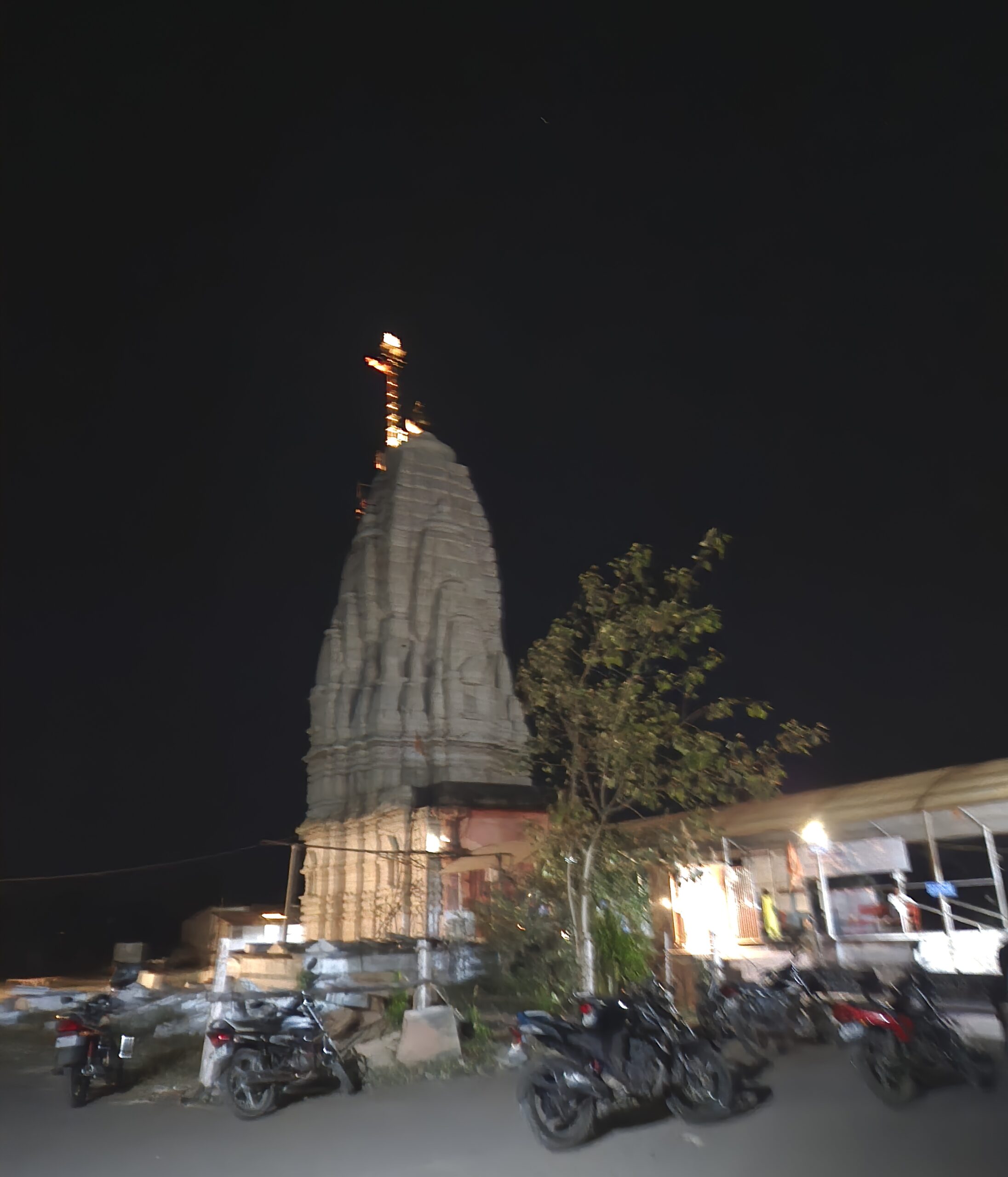 Pale stone shikhara of the second Shiva temple rising into the night sky