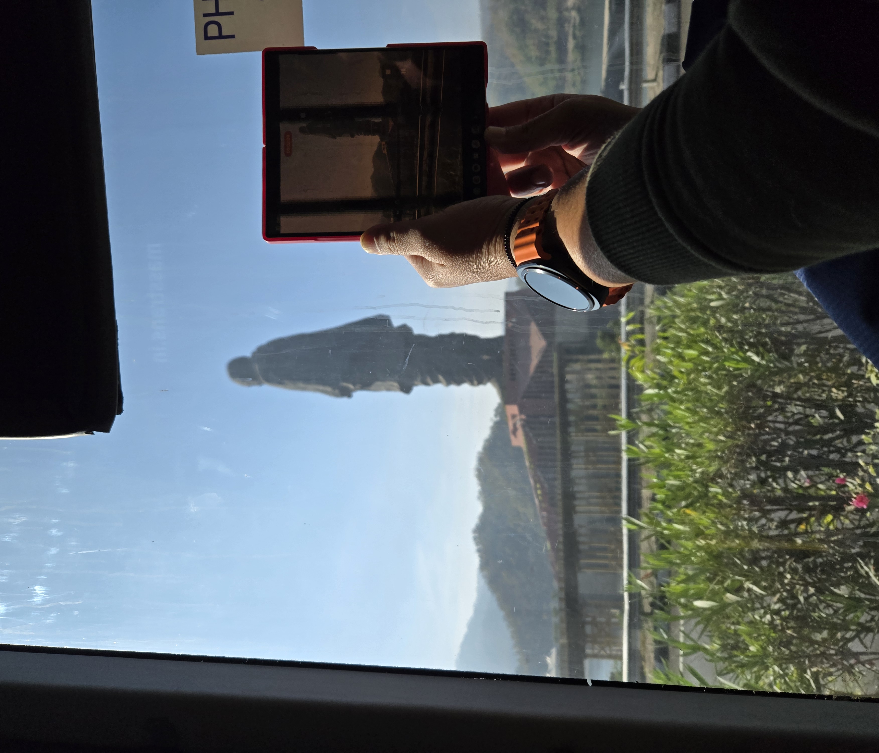 Ruby photographs the Statue of Unity with her Samsung Fold through the shuttle bus window on the way from the parking lot
