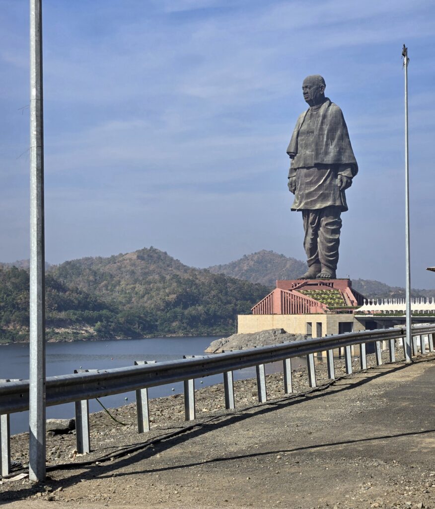Full view of the Statue of Unity rising above the landscape in Gujarat