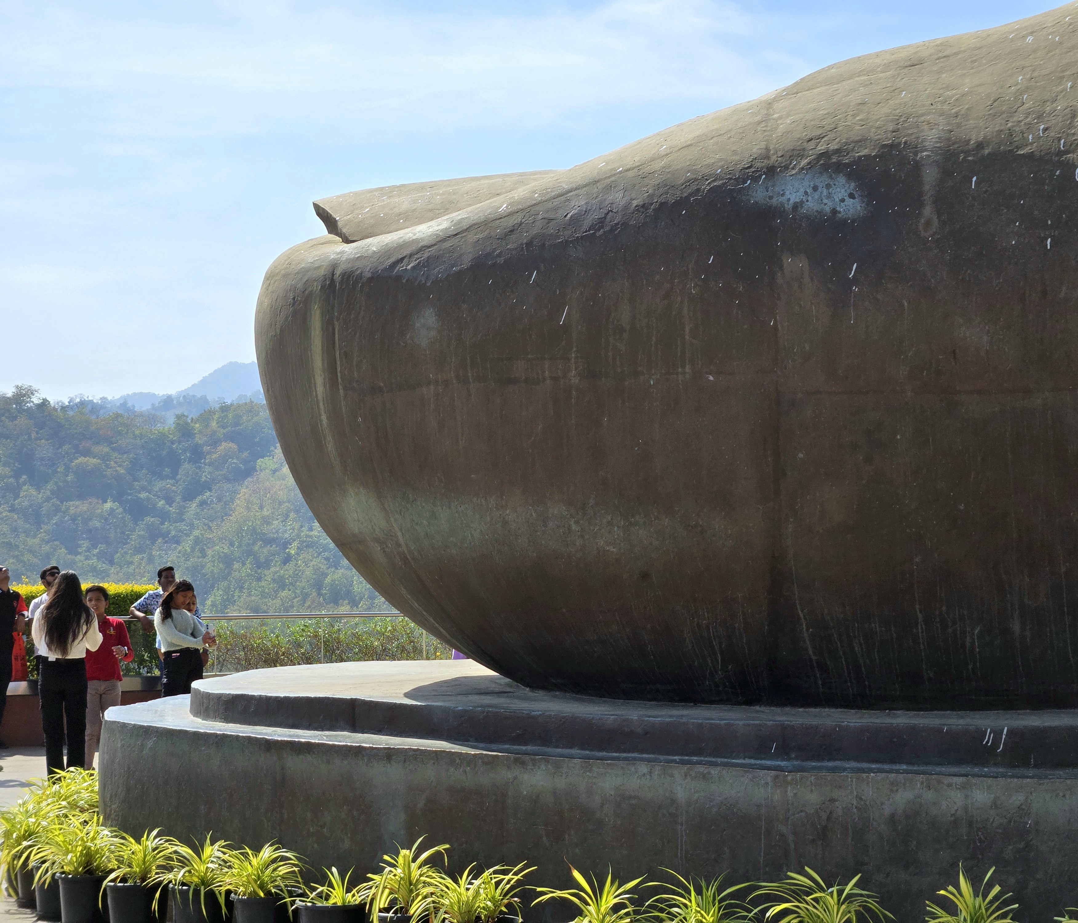 Visitors standing beside the enormous foot of the Statue of Unity