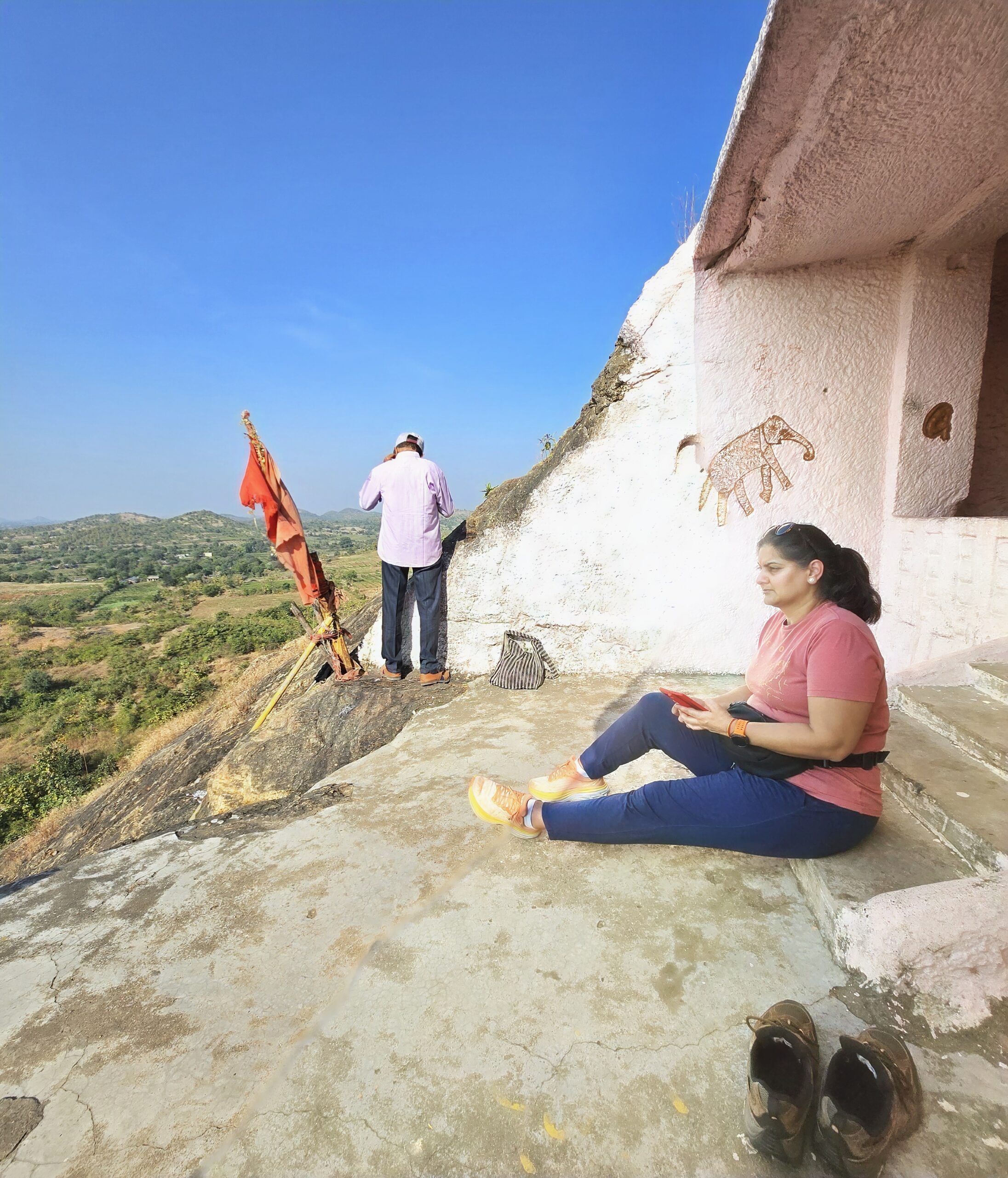 Ruby enjoying the distant landscape outside the pink-painted second meditation room at Kadia Dungar