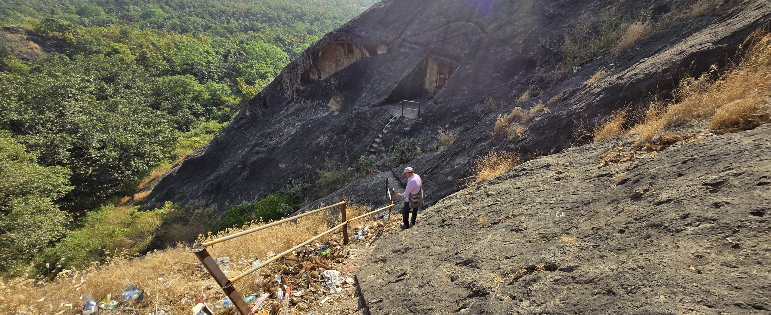 Kishore maasaa descending the rocky steps toward Meditation Room 1 at Kadia Dungar