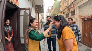 Nilam Chaachi placing a tilak on Ruby’s forehead during a traditional family welcome in Ferozpur