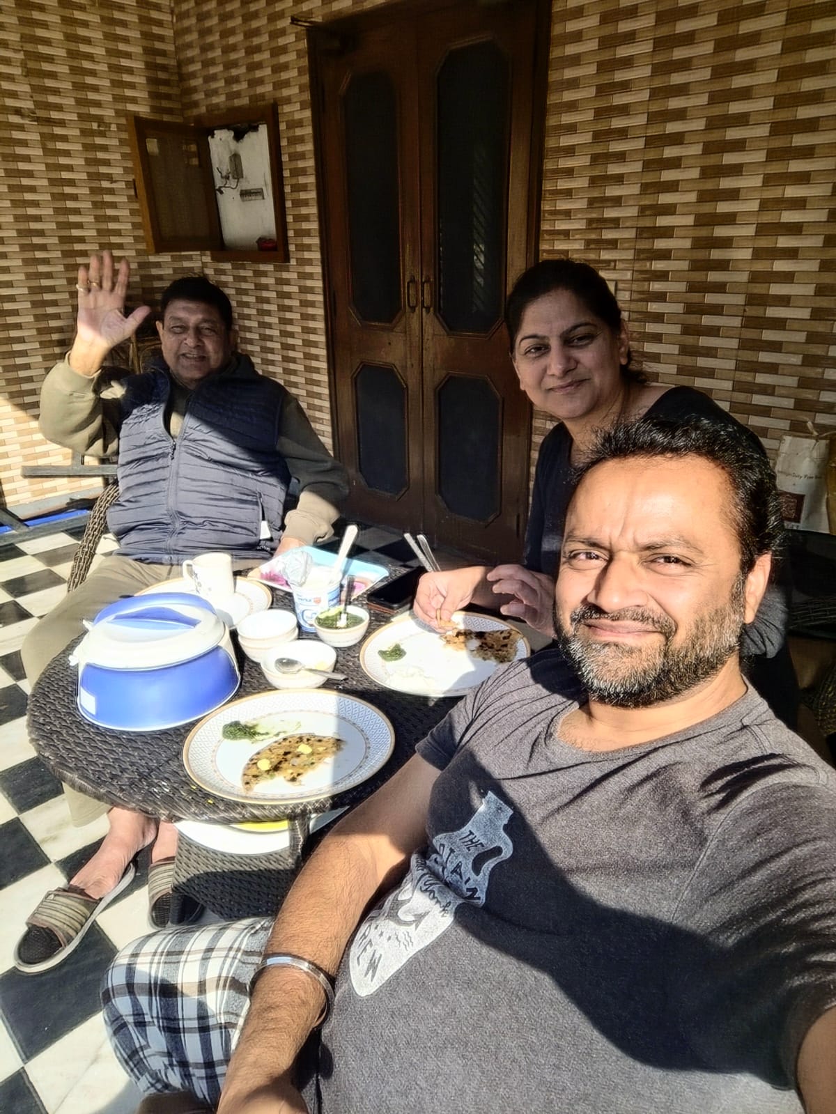Yogz, Ruby, and Ruby's dad having mooli de paranthe on the terrace in Ludhiana