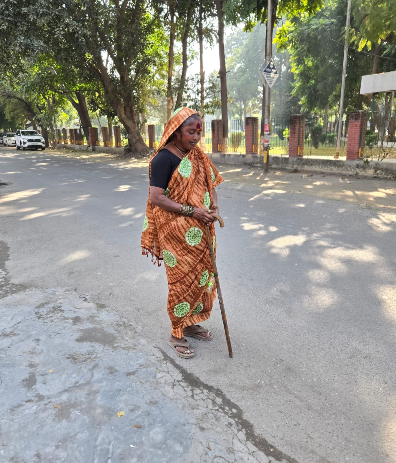 Woman sharing her story with Yogz and Ruby on a neighborhood street in Ludhiana
