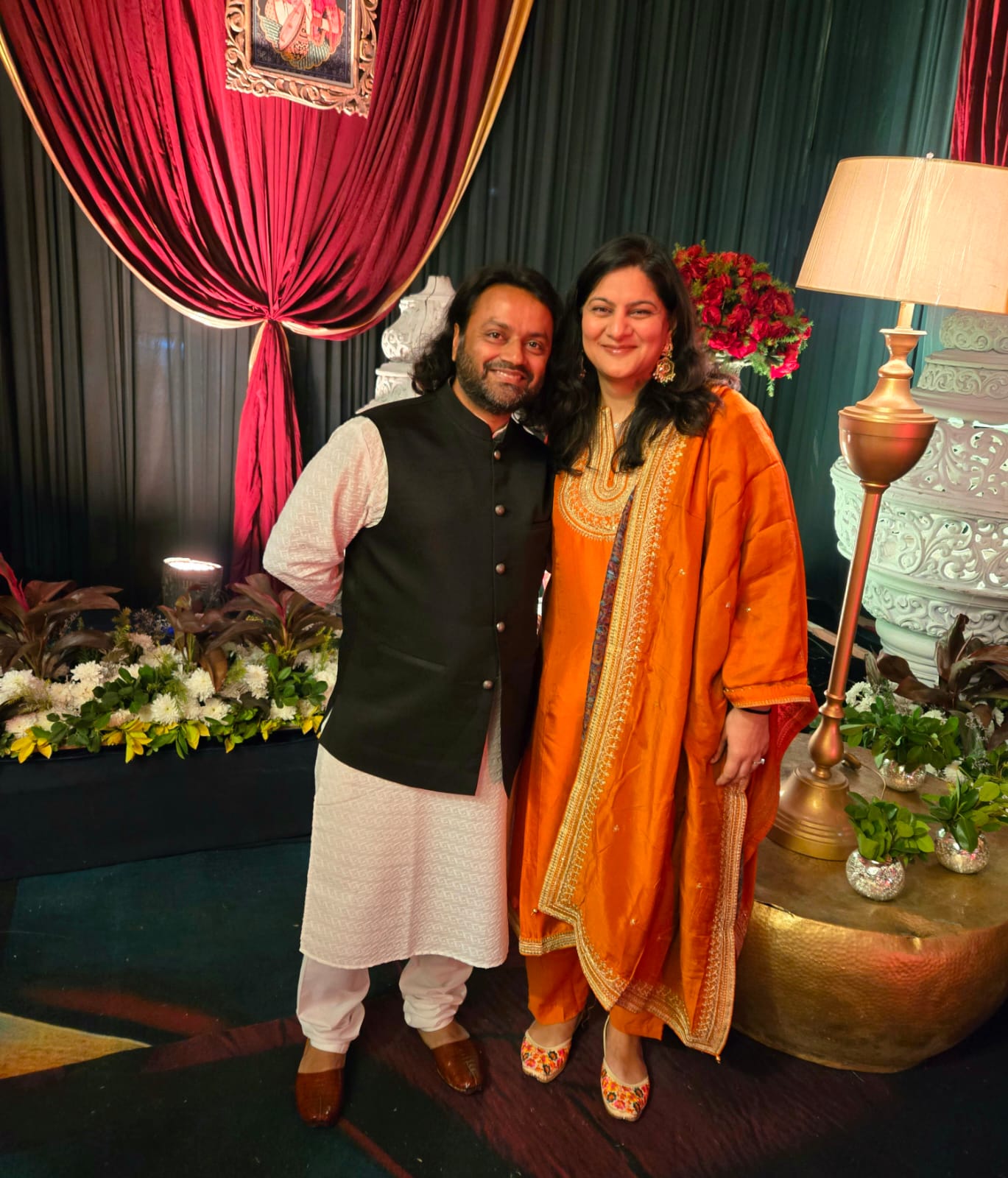 Yogz and Ruby posing in Indian outfits at a wedding reception in Ludhiana